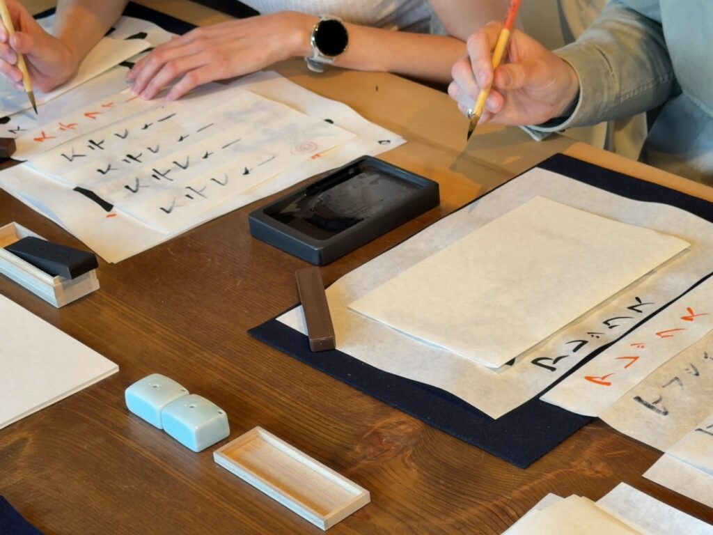Guest from Germany writing a final calligraphy piece on handmade washi paper at Atelier & Gallery Ichirin in Kamakura