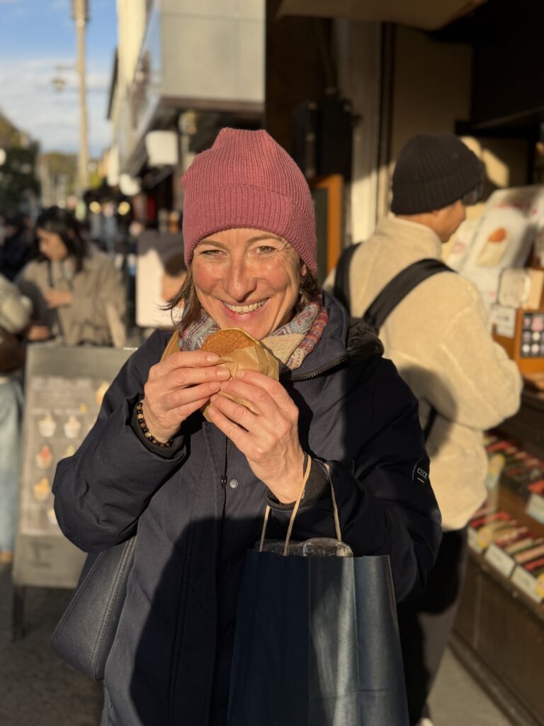 Guest holding Buddha-shaped ningyo-yaki on Komachi Street in Kamakura