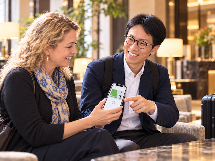Kamakura private guide helping a guest set up Suica on an iPhone